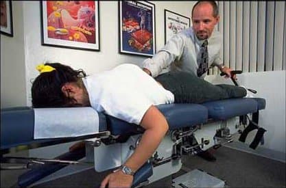 Dr. James Bogash treating a patient on a flexion-distraction table.