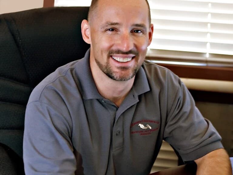 Dr. James Bogash at LifeCare Chiropractic in Mesa, wearing an embroidered LifeCare polo shirt.